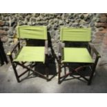 Two wooden framed folding garden chairs with green fabric seats and backs