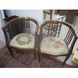 A pair of Edwardian mahogany club shaped salon armchairs