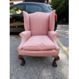 A late 19th/early 20th century mahogany framed wing back arm chair raised on cabriole legs and