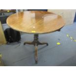 A George III mahogany tripod table with ring turned vase shaped column and grip ring under, standing