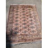 A hand woven Middle Eastern rug, four elephant gulls to the centre within a multi guard boarder,