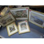 A framed and glazed watercolour of a Highland loch scene with a wooden boat to foreground, castle