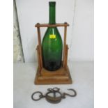 An early to mid century decanter bottle stand/pourer in walnut with brass bases to the top,