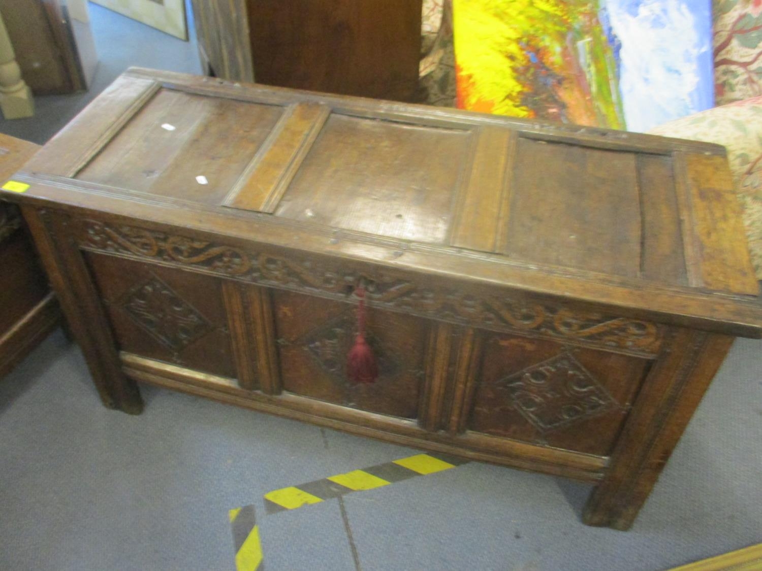 A tri-panelled coffer, circa 1650 with later carved panels, fitted internally A/F. Location:Back Row