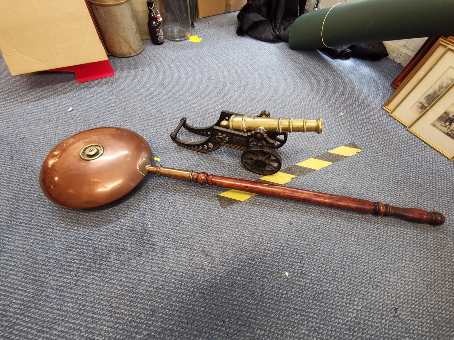 An early 20th century cast iron and brass model cannon and a copper warming pan