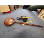 An early 20th century cast iron and brass model cannon and a copper warming pan