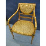 A reproduction painted cane chair