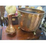 A copper Arts & Crafts cool bucket having brass lion ring handles together with a copper ewer