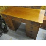 An early 20th century walnut twin pedestal desk with nine drawers