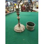 A Victorian candle stick, 10cm high together with a silver napkin ring, 140g Location: Porter