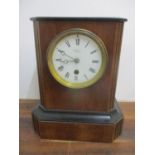 A late 19th century walnut and ebonized mantel clock with a French movement