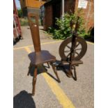 An oak spinning wheel by Haldane together with an oak spinning chair Location: