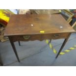 A George III oak side table with two short drawers, later swan neck brass drop handles, shaped apron