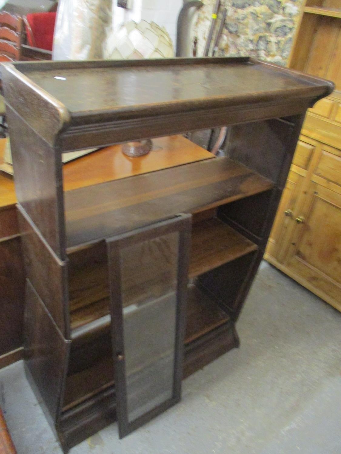 An early 20th century Gunn sectional bookcase of three sections, each having a glazed raising