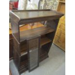 An early 20th century Gunn sectional bookcase of three sections, each having a glazed raising