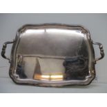 A Christofle silver plated tray with a serpentine outline and twin opposing, double S shaped