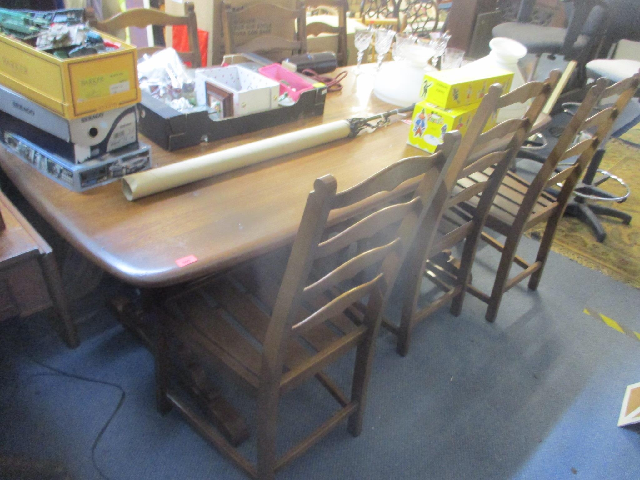 A vintage Ercol dark elm stained table and six chairs