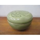 A Chinese green glazed lidded pot with floral decoration to the lid 7cm h x 10cm w