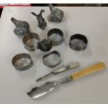 Silver to include five napkin rings, a bottle stopper 125g, silver and mother of pearl fruit/pen