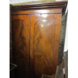 A Victorian mahogany two door wardrobe with coat hooks to the side and on a plinth base 201cm h x