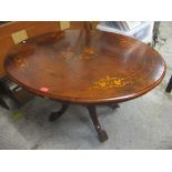 A late Victorian walnut and marquetry loo table, with four turned columns, on splayed legs and