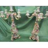 Two German porcelain encrusted candelabras A/F decorated with flora and cherubs Location: rostrum