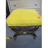 A Victorian ebonized and gilt footstool with yellow upholstered seat, stamped Mackenzie and