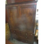 An early 19th century mahogany linen press having two panelled doors revealing four sliding