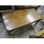 A late 20th century American oak coffee table having an X-framed support 41cm h x 122cm w,