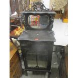 A late Victorian black lacquered cabinet having a raised mirrored top above a single drawer and