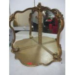 A vintage corner mirror, freestanding with triangular base, scrolled side supports with a central