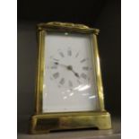 A late 19th century brass five-window carriage clock with enamelled dial and Roman numerals, with