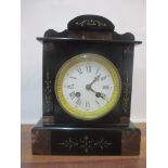 A Victorian black and mottled marble mantel clock