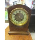 An early 20th oak mantel clock fitted with a French 8 day movement striking on a gong, 26cm h x 18cm