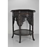 A late 19th century Chinese rosewood decagonal table, with a mitred top, over a floral carved