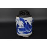 A Chinese Kangxi blue and white porcelain twin handled lidded censer, the body depicting scholars in