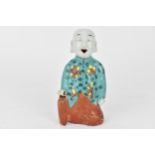 A 19th century Chinese incense burner, a kneeling figure wearing a turquoise floral jacket with a