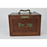 An early 20th century Chinese cased mahjong set with sliding front and fitted drawers, the pieces