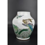 A Chinese Qing dynasty famille verte enamel vase, possibly Kangxi period, of baluster form with