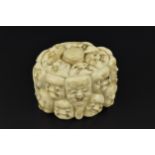 A Japanese carved ivory trinket box, 19th century, modelled with carved Noh theatre masks around the