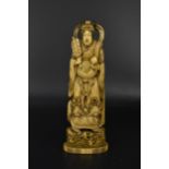 A Japanese Meiji period carved ivory okimono of the deity Xi Wangmu, holding a fan and a peach,