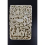 A late 19th century Cantonese carved ivory card case, intricately carved throughout with figures and