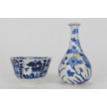 A Chinese Kangxi blue and white tea bowl with a wary rim and tapered sides on a foot decorated to