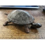 A late 19th.early 20th century clock work cast metal bell in the form of a tortoise marked G.S.S
