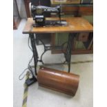 A 1920s Singer sewing machine, serial number Y649892 with oak case and oak and cast iron treadle