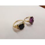 Two 9ct gold rings, one set with an amethyst colour stone, the other with black stone 5.8g Location: