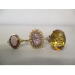 Three 9ct gold rings, one set with a citreen, one a cameo and the other an amethyst