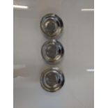 Three silver coloured metal dishes with Theresia coins, 215g