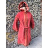 A 1960's Saint Laurent Rive Gauche terracotta coloured ground coat having tasselled hood, belt, 3