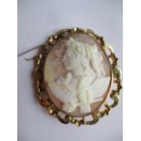 A gold coloured framed cameo